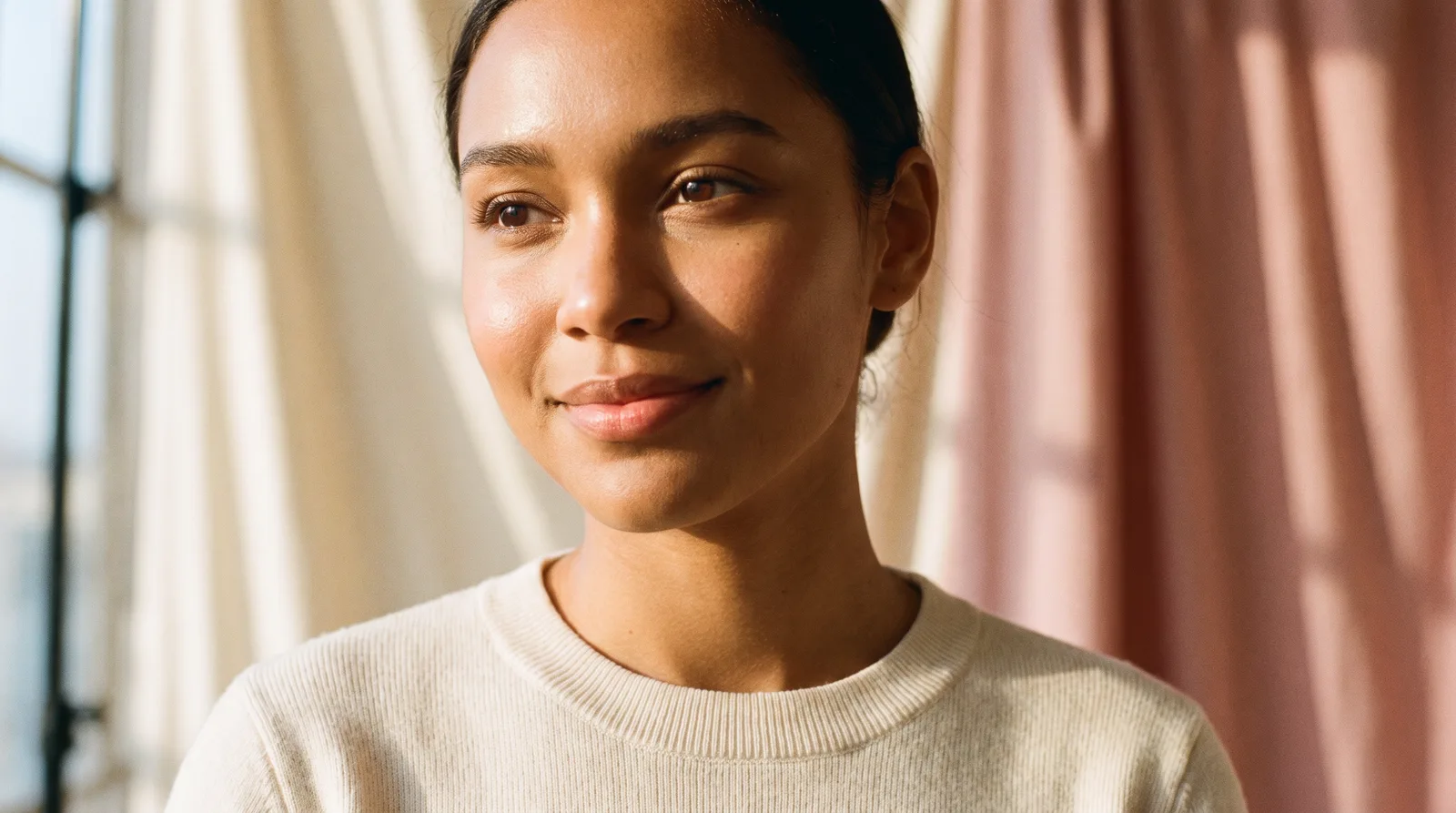 Smiling woman in soft natural light, representing a SimpleFixRx birth control patient
