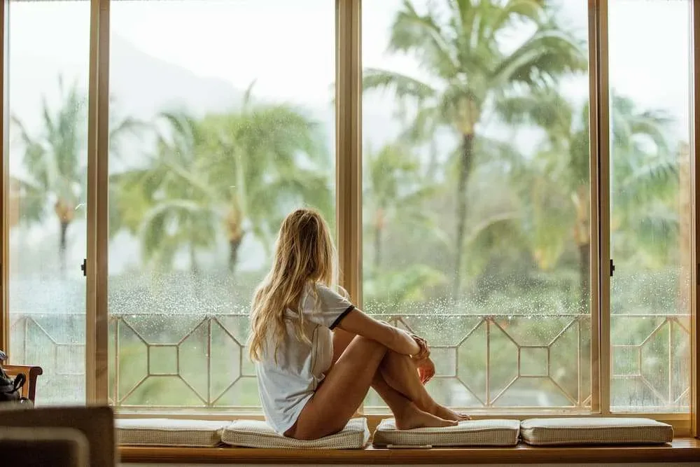 Woman relaxing by a sunny window